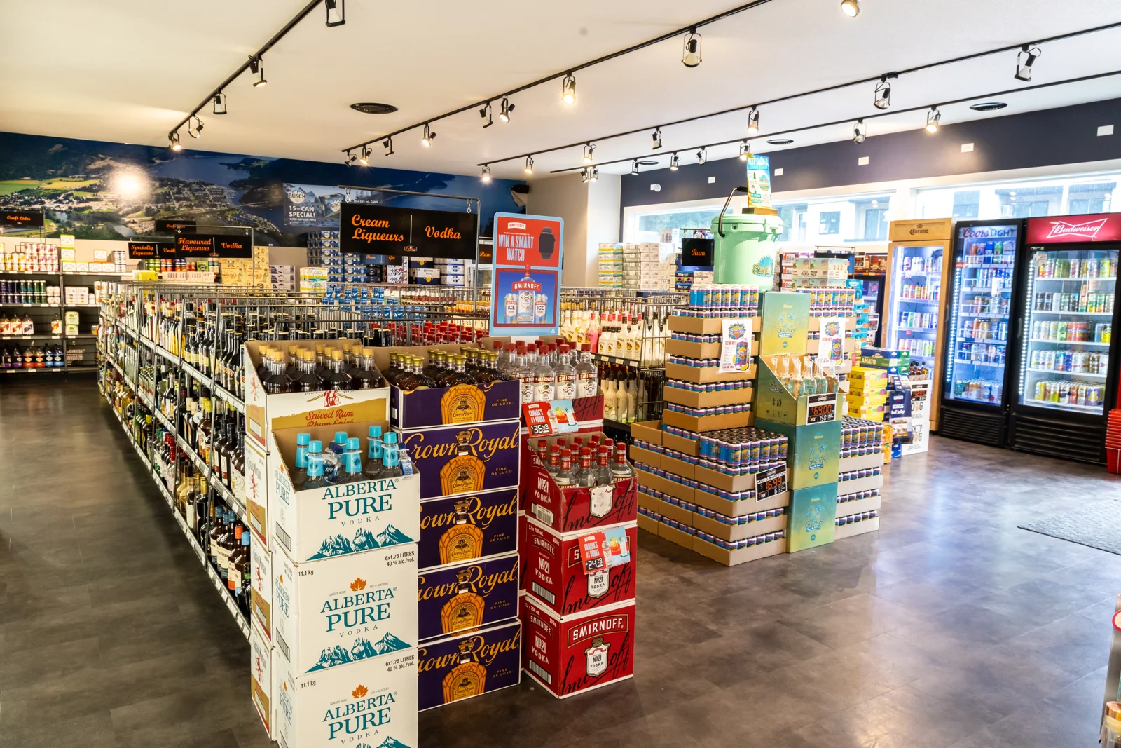 A wide view inside Brothers Liquor Store, with stocked aisles and refrigerated drinks